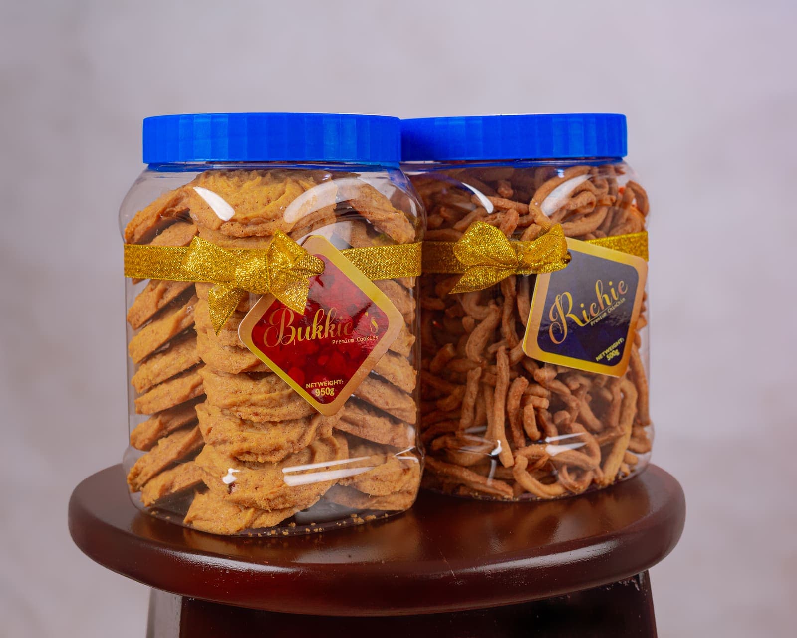A jar of Bukkie's cookies beside a jar of Richie chinchin